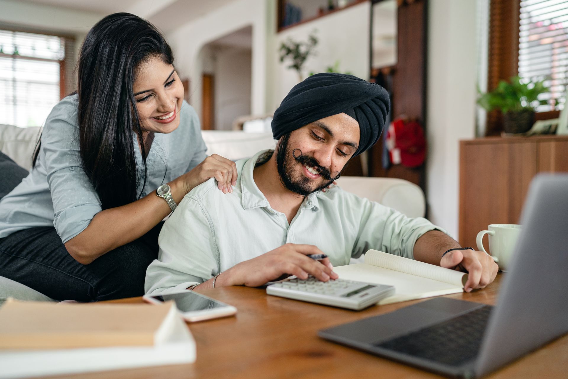 A couple reviewing paperwork together at home, representing gathering partner visa evidence